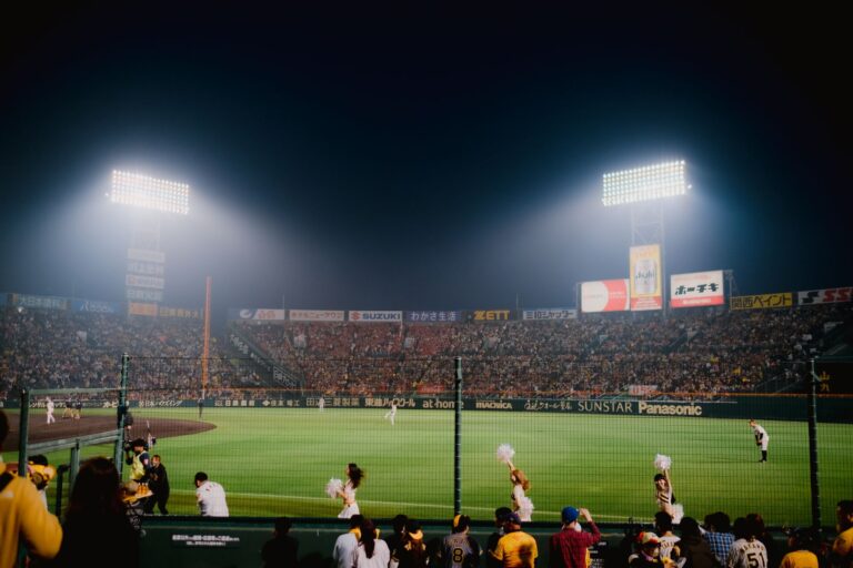 Thrilling night baseball game at Hanshin Koshien Stadium in Japan with vibrant crowd.